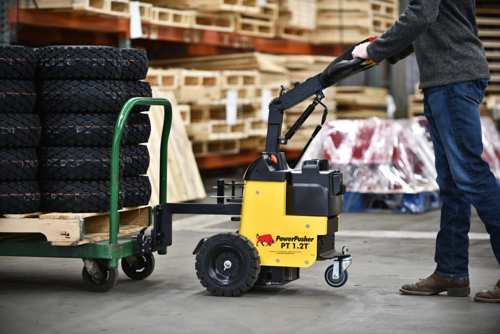 Battery-powered PT 1.2T™ tug moving multiple boxes in a storage facility