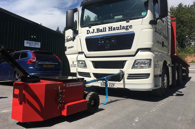 Heavy-Duty Trailer Mover™ towing a full-sized passenger bus on an industrial trailer