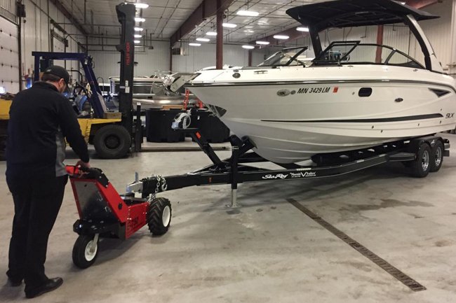 E-750 Trailer Mover™ towing a boat on a trailer in an industrial setting