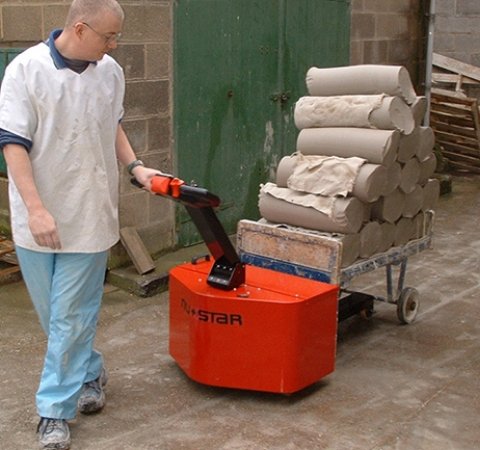 Side profile of Extra-Duty PowerPusher™ showcasing compact design and solid rubber tires.