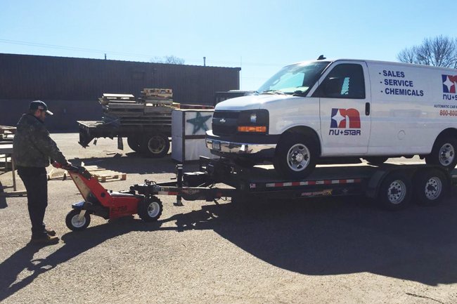 E-750 Trailer Mover™ towing a full-size van in an industrial setting