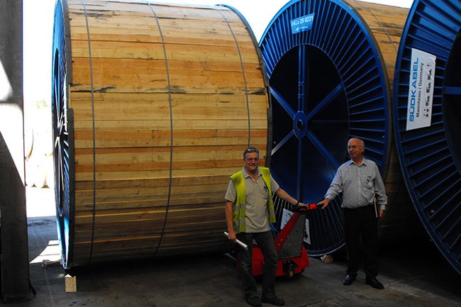 Dual-Motor Super PowerPusher™ transporting large paper reels in a manufacturing facility
